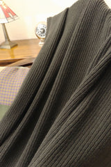 Cashmere blanket in dark green close-up