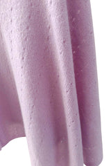 Close-up of a textured purple fabric with a white background